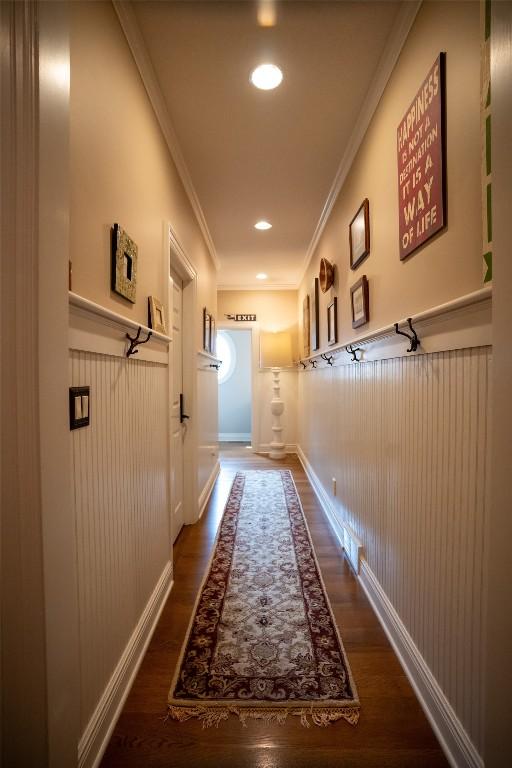 corridor featuring dark hardwood / wood-style floors and ornamental molding