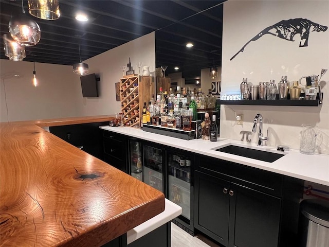 bar featuring sink and decorative light fixtures