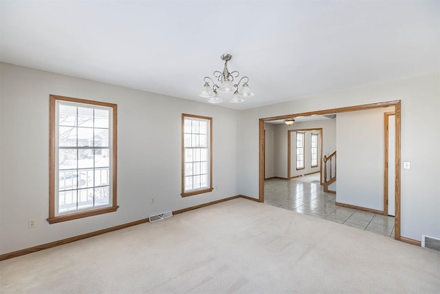 3706 Harbor Ridge Trl, Erie, PA 16510 - empty room featuring a chandelier, light carpet, baseboards, stairway, and light tile patterned floors
