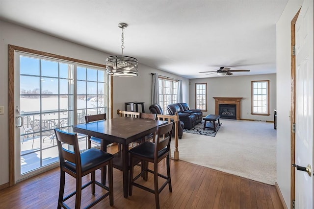 3706 Harbor Ridge Trl, Erie, PA 16510 - dining room with ceiling fan, a chandelier, hardwood / wood-style flooring, and a glass covered fireplace