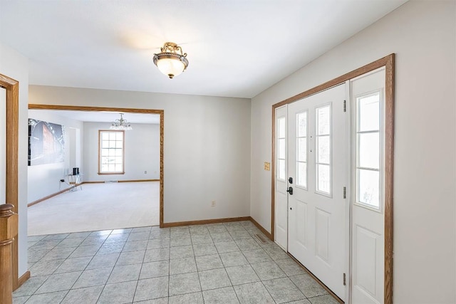 3706 Harbor Ridge Trl, Erie, PA 16510 - foyer featuring a chandelier, baseboards, light colored carpet, and light tile patterned floors