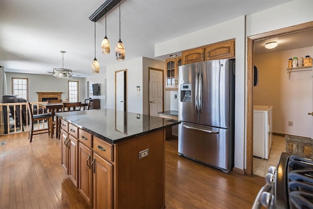 3706 Harbor Ridge Trl, Erie, PA 16510 - kitchen with stainless steel fridge, ceiling fan, brown cabinetry, a center island, and hardwood / wood-style floors