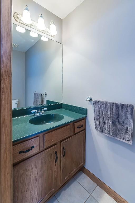 3706 Harbor Ridge Trl, Erie, PA 16510 - half bathroom featuring vanity, tile patterned floors, and toilet