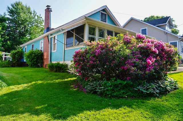 105 Hickory St, Edinboro, PA 16412 - view of property exterior with a chimney and a lawn