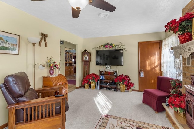 living room featuring carpet floors and ceiling fan