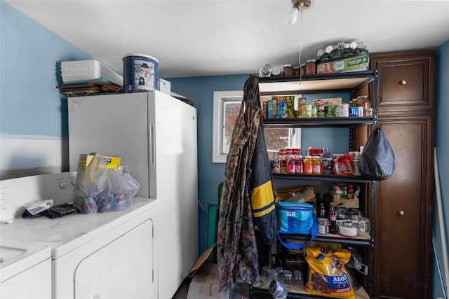 clothes washing area with washer and clothes dryer