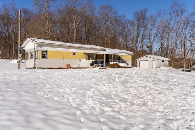 exterior space featuring an outbuilding, a garage, and covered porch