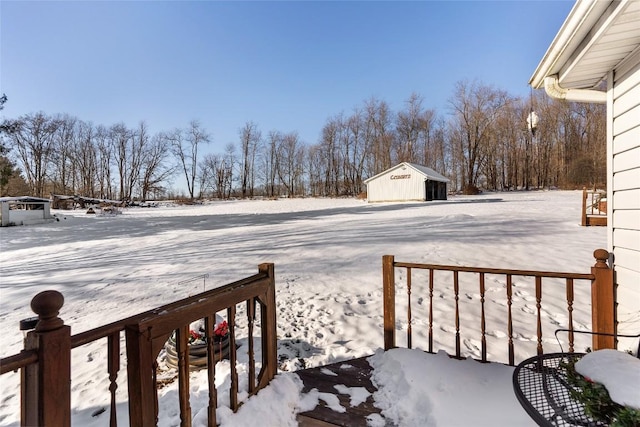 yard covered in snow with an outdoor structure