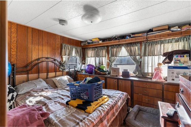 bedroom featuring wood walls