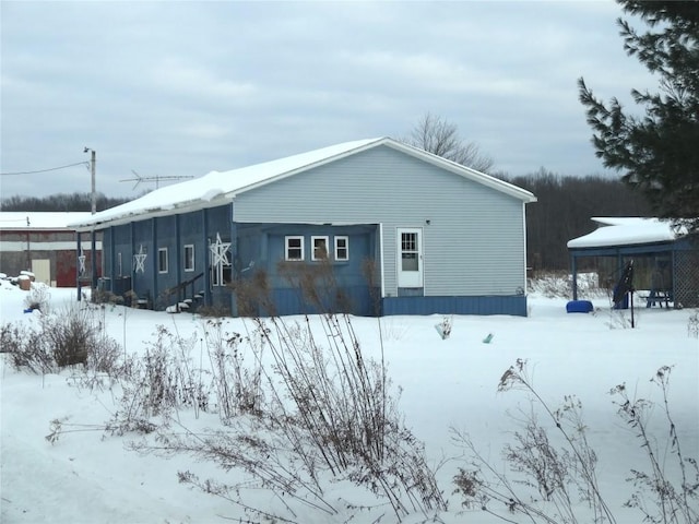 view of snowy exterior featuring a garage