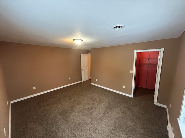 empty room featuring dark carpet