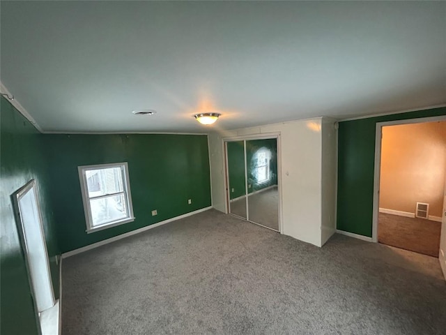 unfurnished bedroom featuring carpet floors and a closet