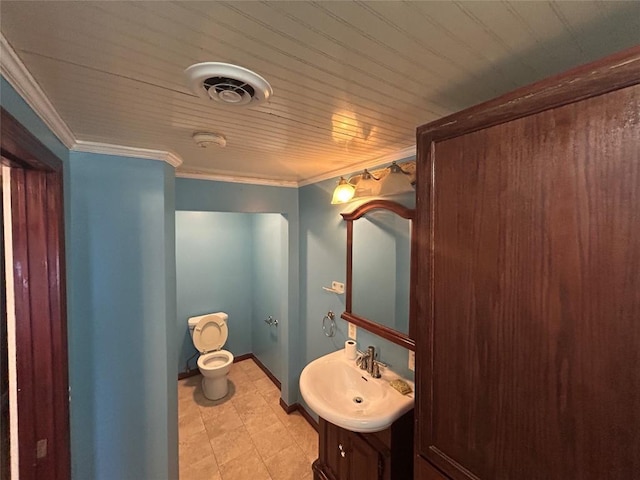 bathroom featuring crown molding, vanity, and toilet