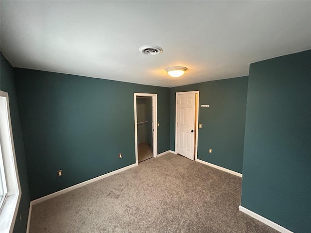 unfurnished bedroom with carpet floors and a closet