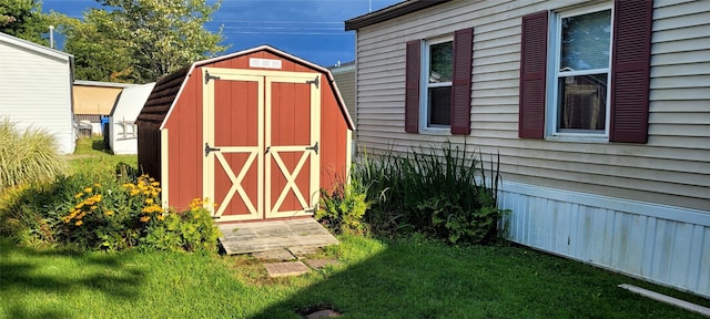 view of outdoor structure featuring a lawn