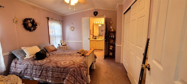 bedroom featuring connected bathroom, ceiling fan, crown molding, carpet floors, and a closet