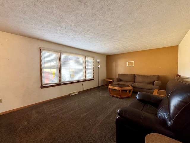 carpeted living room with a textured ceiling, visible vents, and baseboards