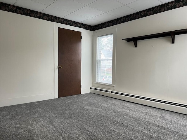 carpeted spare room featuring a baseboard radiator