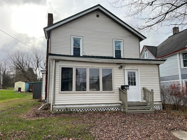 rear view of house with a lawn