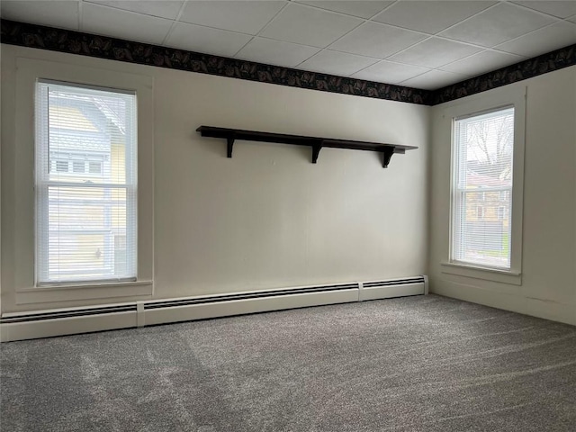 unfurnished room featuring carpet flooring, a paneled ceiling, and a baseboard radiator