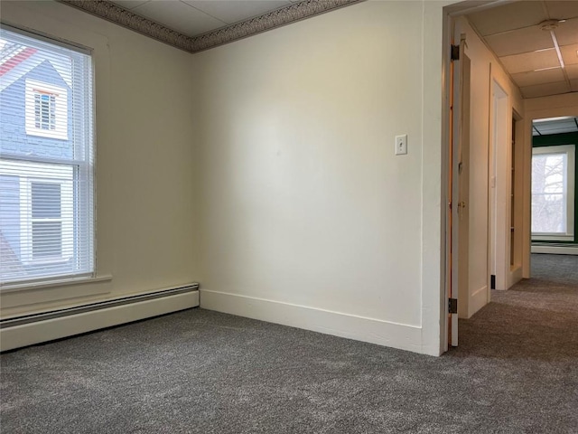 empty room featuring carpet flooring and a baseboard radiator