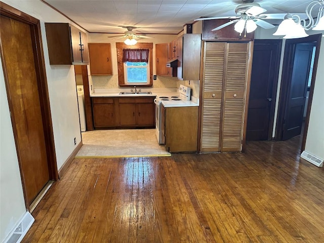 kitchen with white range with electric stovetop, tasteful backsplash, light hardwood / wood-style floors, and sink