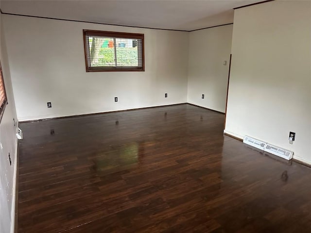 empty room featuring dark hardwood / wood-style flooring