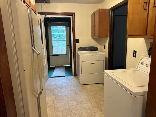 laundry room featuring cabinets and washing machine and dryer