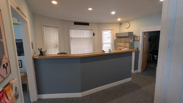 kitchen featuring kitchen peninsula and dark carpet