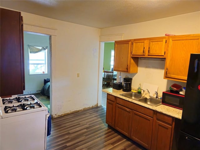 402 Reed St, Erie, PA 16507 - kitchen featuring black appliances, light countertops, dark wood-type flooring, and brown cabinetry