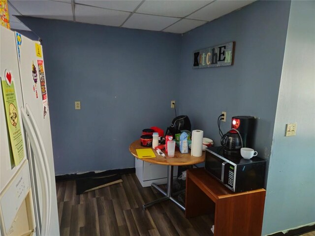 402 Reed St, Erie, PA 16507 - kitchen with white fridge with ice dispenser, wood finished floors, a paneled ceiling, and stainless steel microwave