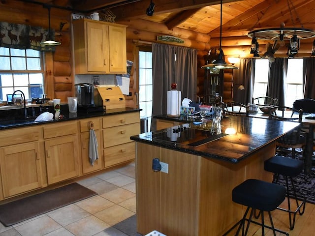 kitchen with pendant lighting, vaulted ceiling with beams, wood ceiling, and log walls