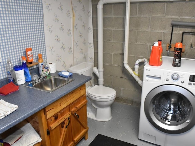 bathroom featuring washer / clothes dryer, toilet, and sink