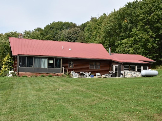 rear view of property featuring a lawn