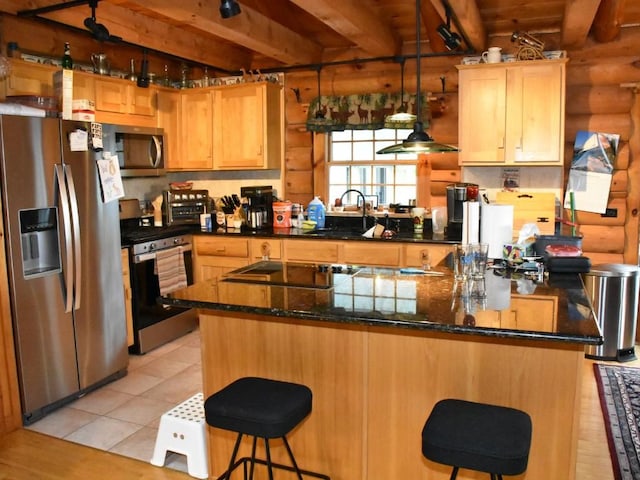 kitchen with a kitchen breakfast bar, sink, log walls, and stainless steel appliances