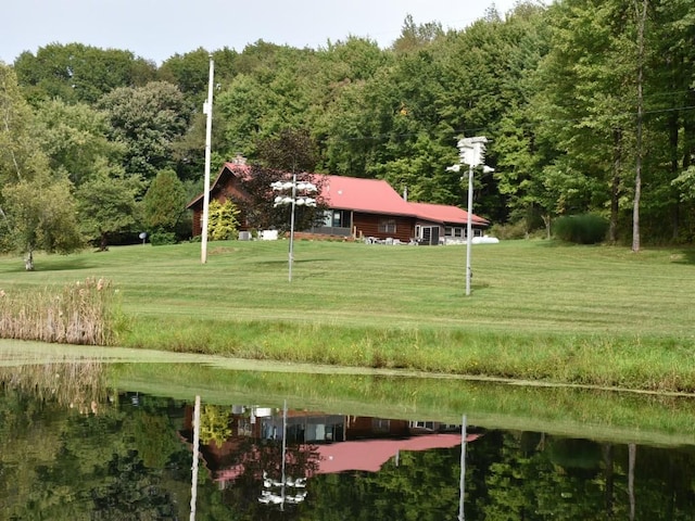 view of property's community featuring a water view and a lawn