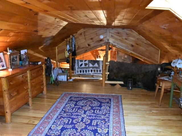 bedroom featuring vaulted ceiling, wood walls, and wood ceiling