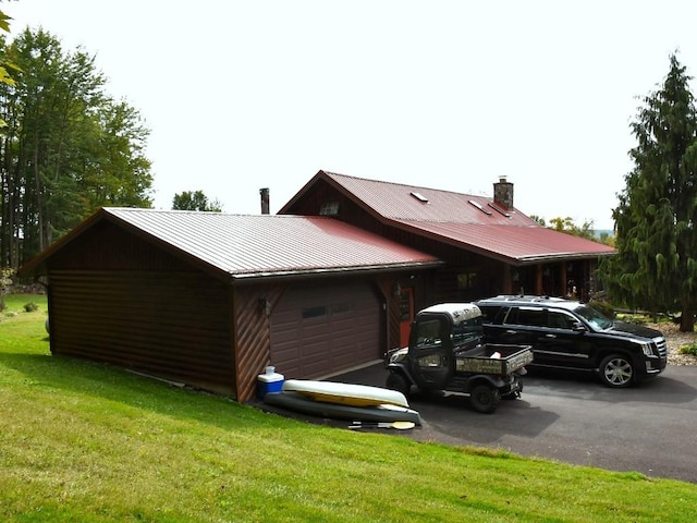 exterior space with a yard and a garage