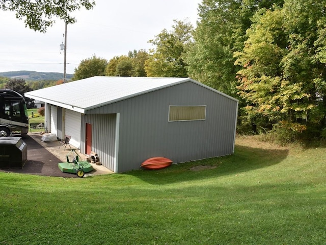 view of outbuilding featuring a yard and a garage