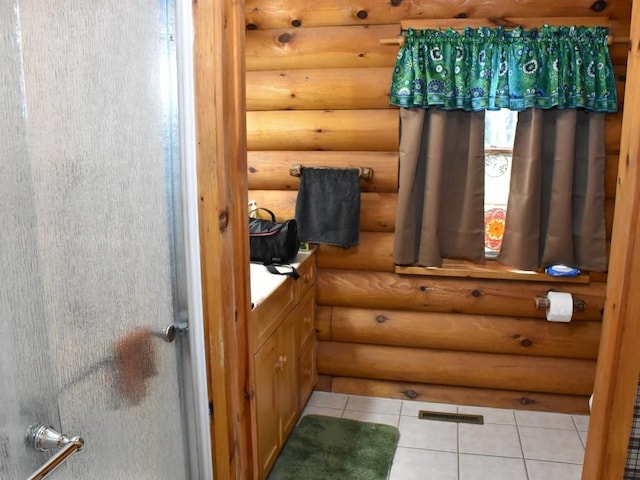 bathroom with tile patterned floors and rustic walls