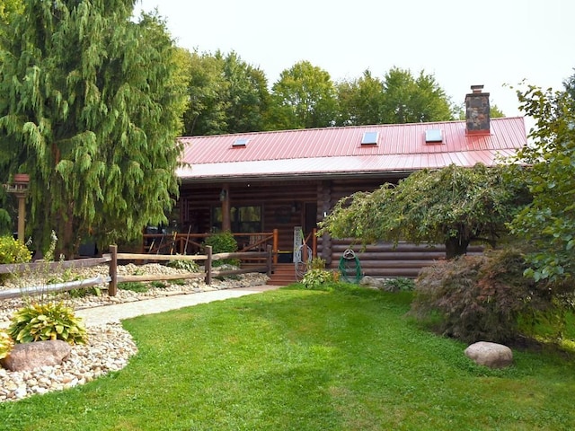 rear view of property with a lawn