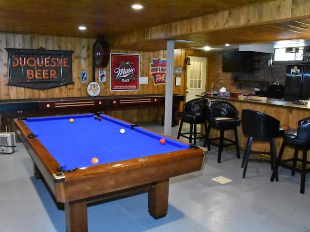 recreation room featuring billiards and wooden walls