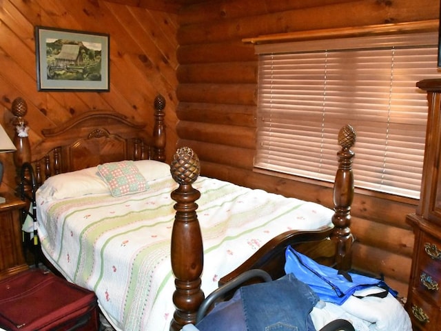 bedroom featuring log walls