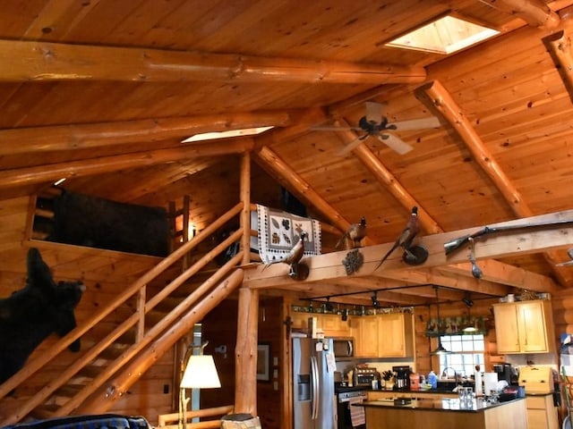 kitchen with vaulted ceiling with skylight, wooden ceiling, and appliances with stainless steel finishes