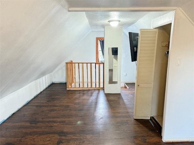 additional living space with dark hardwood / wood-style floors and lofted ceiling