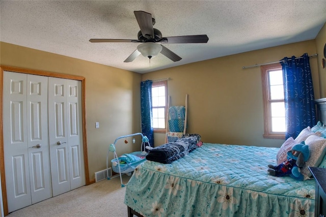 6020 Pebble Creek Dr, Fairview, PA 16415 - bedroom featuring carpet floors, a closet, multiple windows, a textured ceiling, and ceiling fan