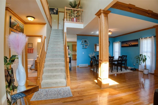 6020 Pebble Creek Dr, Fairview, PA 16415 - foyer entrance with decorative columns, crown molding, wood finished floors, and stairs