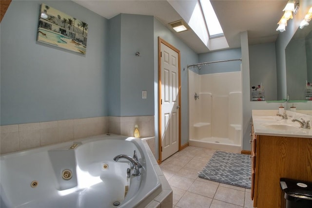 6020 Pebble Creek Dr, Fairview, PA 16415 - bathroom with a tub with jets, tile patterned floors, a stall shower, a skylight, and vanity