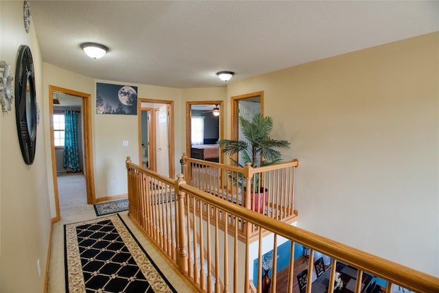 6020 Pebble Creek Dr, Fairview, PA 16415 - hall with an upstairs landing, a textured ceiling, and light carpet