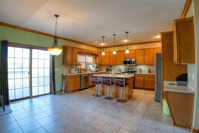 6020 Pebble Creek Dr, Fairview, PA 16415 - kitchen with stainless steel appliances, ornamental molding, a kitchen island, a kitchen bar, and brown cabinetry